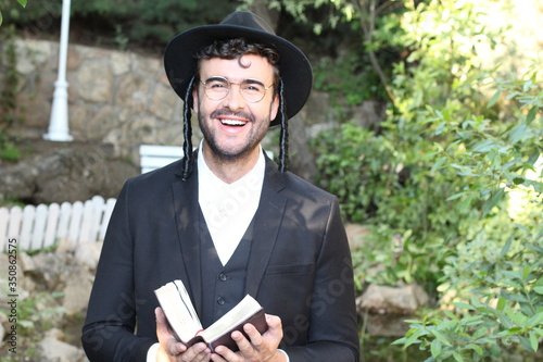 Cute Jewish man smiling outdoors 