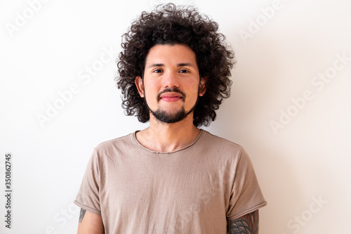 Latin American model smiling, casual look, neutral background 
