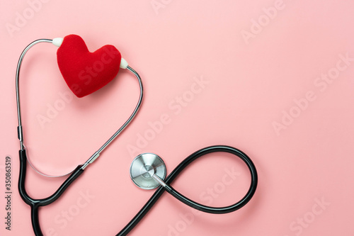 Table top view aerial image of accessories healthcare & medical with Valentines day background concept.Flat lay stethoscope with sign treatment heart shape sick on pink paper.National Organ Donor Day.