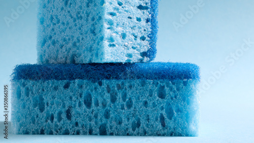 Two blue sponges used for washing and erasing dirt used by housewives in everyday life. They are made of porous material such as foam. Detergent retention, which allows you to spend it economically