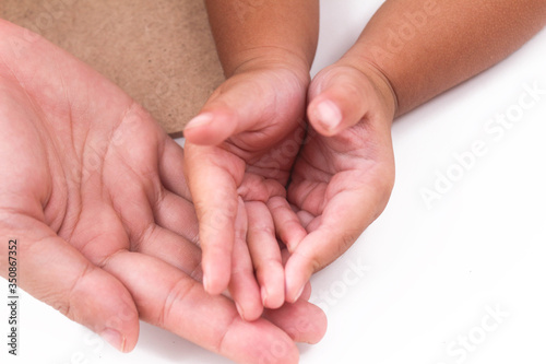Warming hand of baby and mother is touching each other, this picture is about the relation of mother and baby or mother's day or loving.
