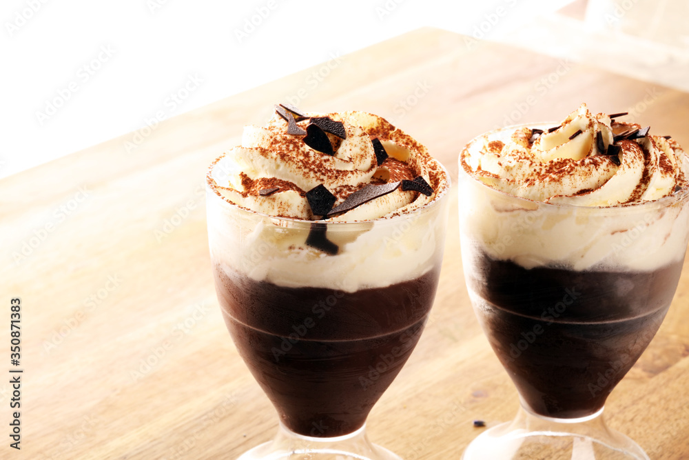 hot chocolate with cocoa and whipped cream on rustic background hot chocolate with cocoa and whipped cream on rustic background