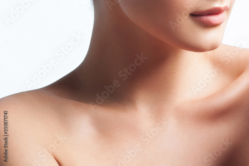 Clavicle, neck and lips of young woman close-up