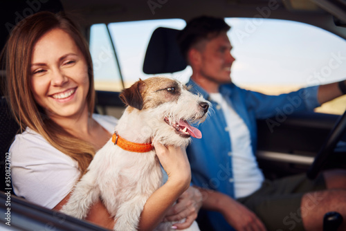 Happiness couple and their dog traveling together.