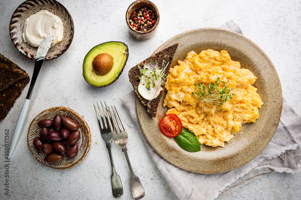 Fresh cooked scrambled eggs in a plate on white background, top view Fresh cooked scrambled eggs in a plate on white background, top view