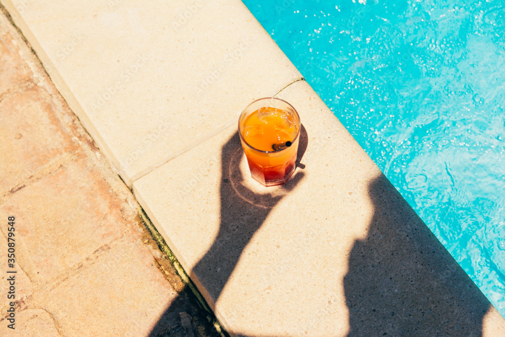 orange cocktail at the pool