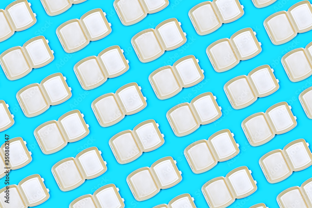 Pattern made of food delivery package or lunch box on pastel blue color background. Catering. Delivery Service in coronavirus epidemic. Pattern made of food delivery package or lunch box on pastel blue color background. Catering. Delivery Service in coronavirus epidemic.