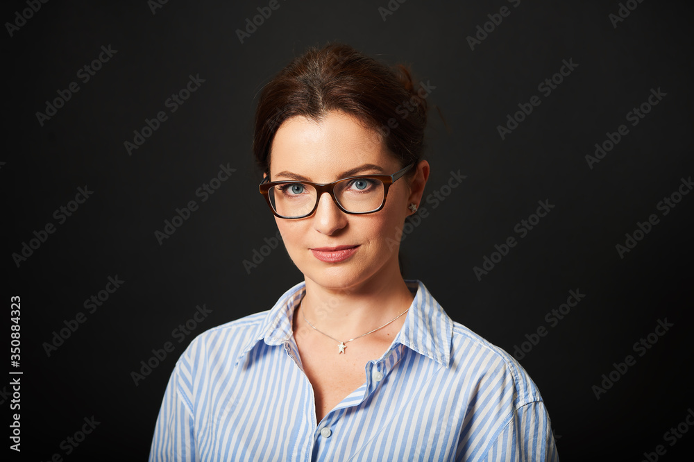 Studio business portrait of beautiful mature woman wearing blue stripe shirt Studio business portrait of beautiful mature woman wearing blue stripe shirt