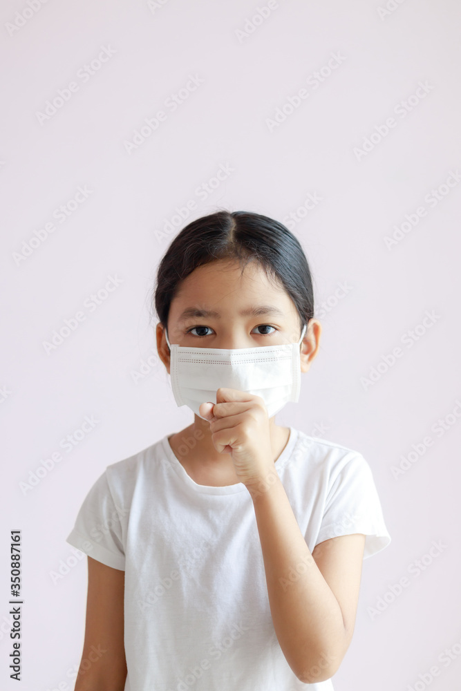 Portrait of Asian little girl wears a sanitary mask and coughs Portrait of Asian little girl wears a sanitary mask and coughs