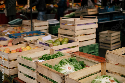 Wooden boxes with fresh salad, vegetables and fruit at a local farmers' market