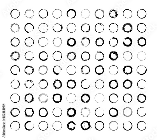 Collection of textured round frames isolated on white background. Set of black templates with splashes and spray in form circle and o-shaped, and elliptical in a dirty and freehand style. © Marina