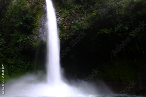 Long exposure of a large waterfall located in the center of an Amazon jungle