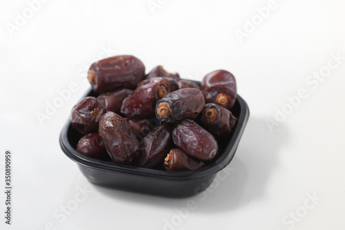Dried dates fruits on white background, tasted sweet and chewy