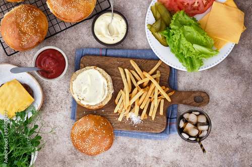 Burger with french fries and ingredients. Top view.