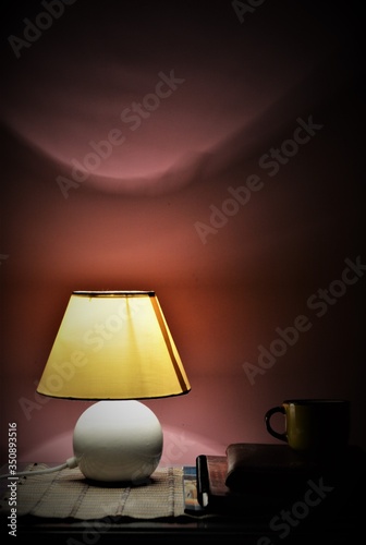 amazing view of room interior with night lamp, books and tea cup