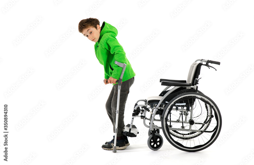 boy gets up from wheelchair , Wheelchair user gets up, moves away from the wheelchair , Young male person got up from a wheelchair as a result of rehabilitation boy gets up from wheelchair , Wheelchair user gets up, moves away from the wheelchair , Young male person got up from a wheelchair as a result of rehabilitation
