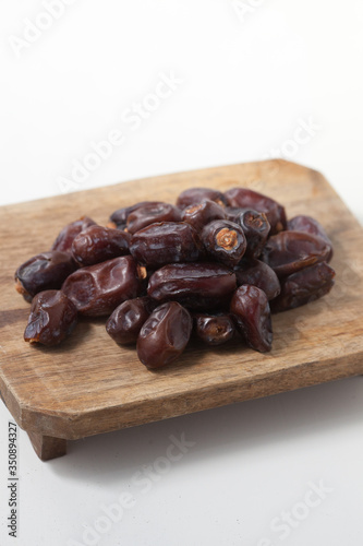 Dried dates fruits on white background, tasted sweet and chewy