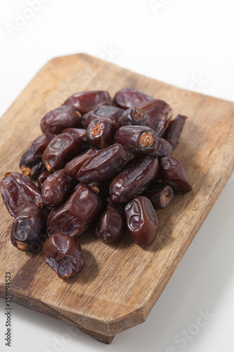 Dried dates fruits on white background, tasted sweet and chewy photo