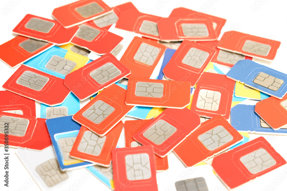 Many multi-colored sim cards are isolated on a white background. Digital chips for quick access to the Internet. Communication concept.