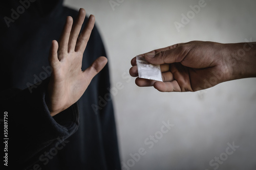 Photography A woman making a stop gesture to drugs, Stop drugs concept