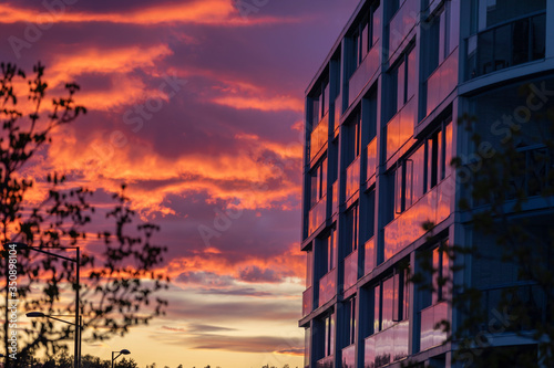 Spectacular urban sunset with light reflected from modern building exterior with no people in scene photo