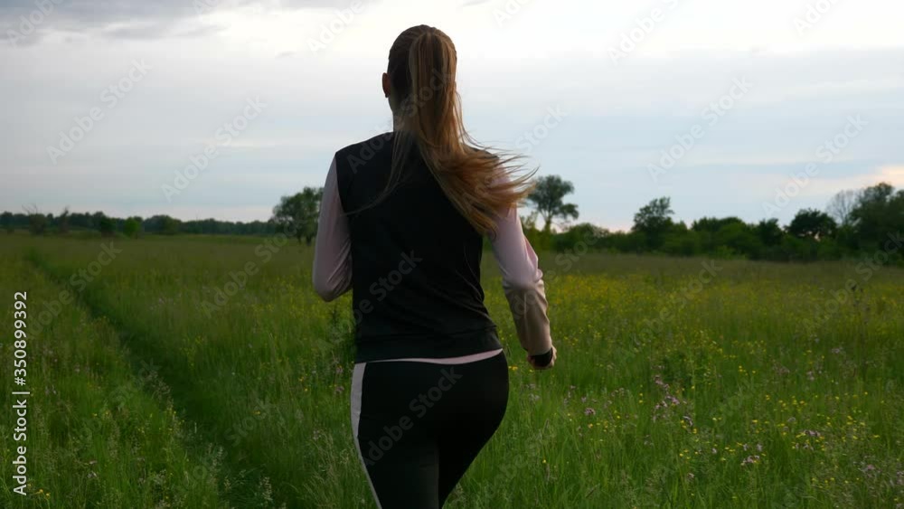 Woman Running Jogging in Grass Field. Countryside Rural Scenery. Rainy Clouds Weather Spring season. 2x Slow motion - 1/2 speed of 60 FPS. Woman Running Jogging in Grass Field. Countryside Rural Scenery. Rainy Clouds Weather Spring season. 2x Slow motion - 1/2 speed of 60 FPS.