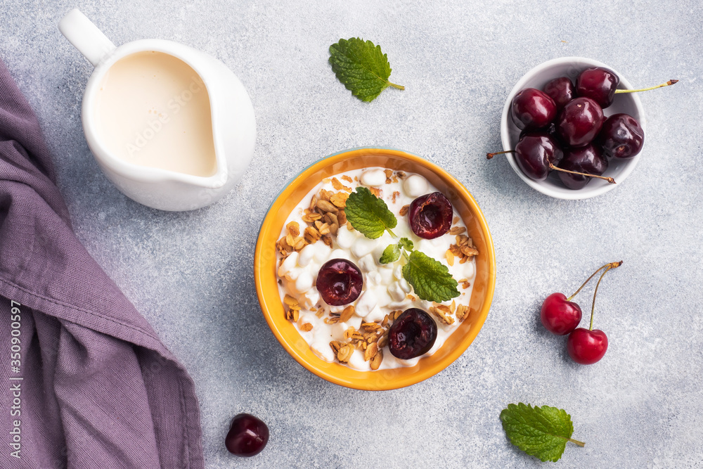 Grain curd muesli with fresh cherries on a plate. Concept healthy Breakfast with cottage cheese and berries. Copy space