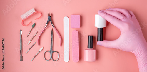 Canvas Print A set of tools for manicure and pedicure in white and pink on a pink background