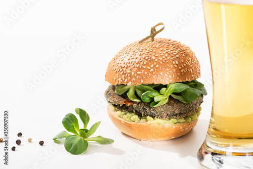 delicious green vegan burger with microgreens, olive oil, black pepper on white background