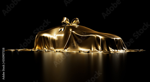Expensive car gift covered by gold shiny fabric with bow-knot isolated on a black studio background. Luxury surprise item. 3D photorealistic illustration