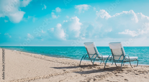 Fototapeta Naklejka Na Ścianę i Meble -  Two beach chairs on tropical vacation, relax at sea