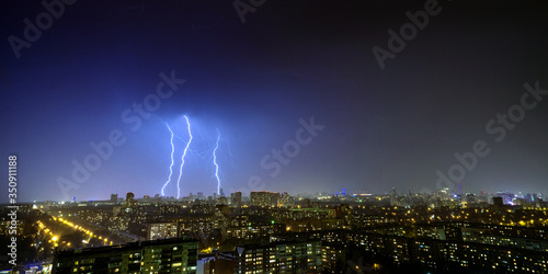 Lightning strikes in the night sky over the night town 3