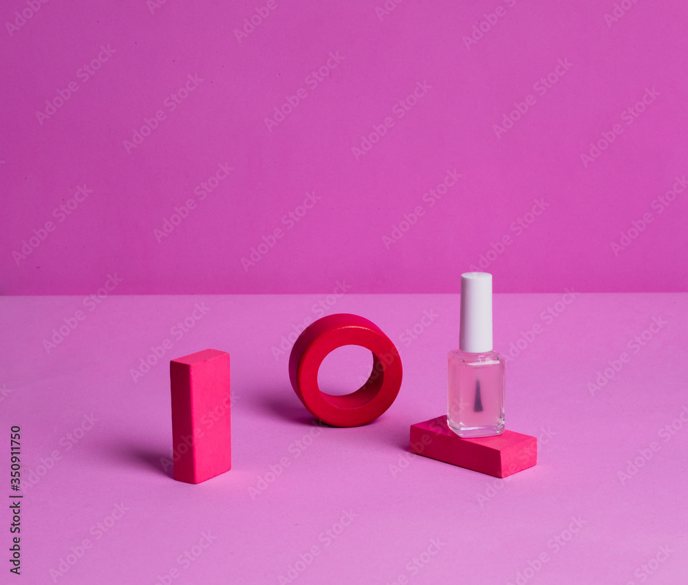 Nail care product on a painted wooden stand on a pink background Nail care product on a painted wooden stand on a pink background