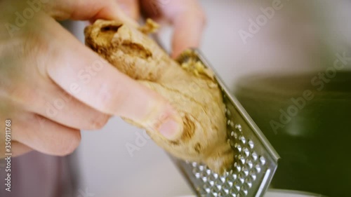 Wallpaper Mural Hand grating a fresh ginger root. Natural food preparation by home cook. Close up, shot in Pro Res Torontodigital.ca