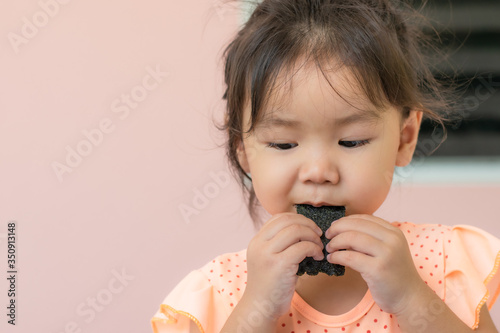 Asian girls eating seaweed snacks