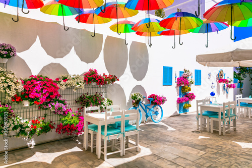 Fototapeta Naklejka Na Ścianę i Meble -  Charming bar decoration design in retro style with old bicycle,umbrellas and flowers