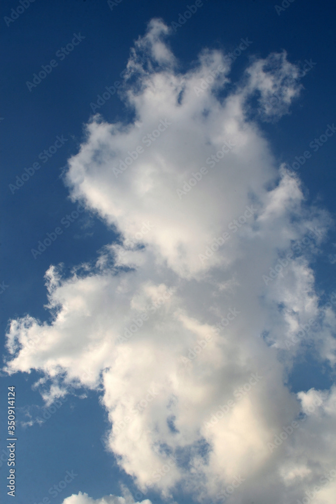 Beautiful light overcast clouds on a background of blue sky