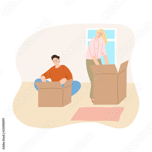 Young couple unpacking boxes in their new apartment
