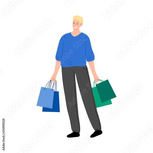 Young man carrying shopping bags during sales