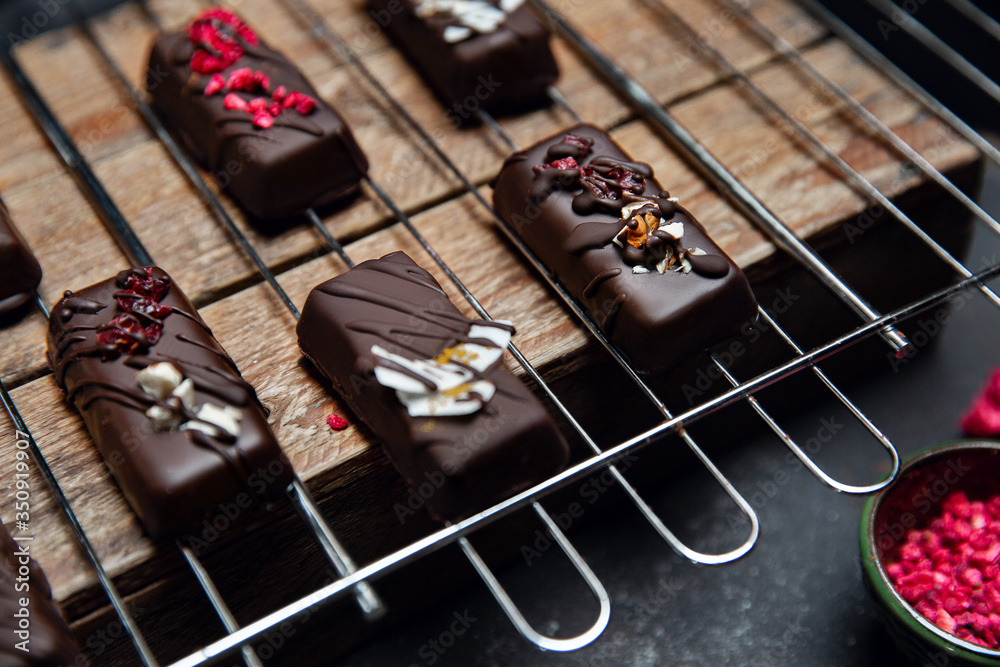 Chocolate candies without sugar on the kitchen grill. Raw vegan