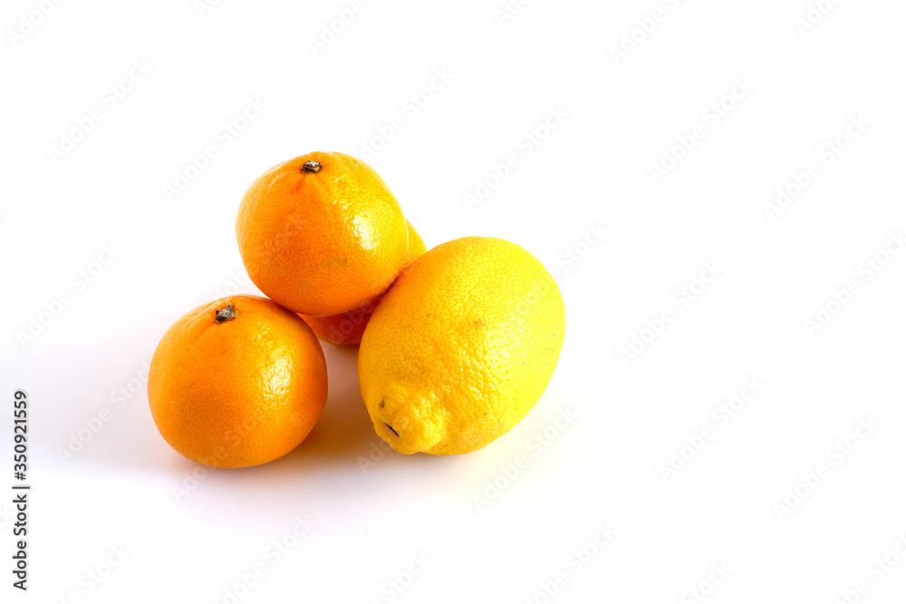 Tangerines and lemon on a white background. Citrus fruits are useful. Vitamin complex Tangerines and lemon on a white background. Citrus fruits are useful. Vitamin complex