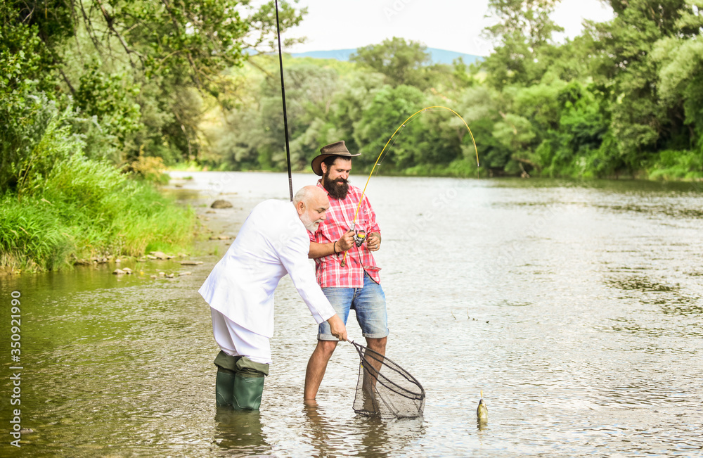 Relax in natural environment. Elegant bearded man and brutal hipster fishing. Hobby and recreation. Summer vacation. Family day. Fishing team. Friends fishing. Perfect weekend. Successful catch Relax in natural environment. Elegant bearded man and brutal hipster fishing. Hobby and recreation. Summer vacation. Family day. Fishing team. Friends fishing. Perfect weekend. Successful catch