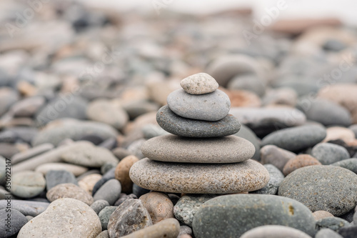 stones on the beach in the shape of a pyramid. balance and meditation  space for text