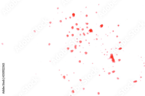 Splashes of small drops of red wine on a white background isolated