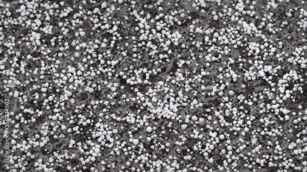 Sleet falling on pavement abstract close up slow motion Sleet falling on pavement abstract close up slow motion