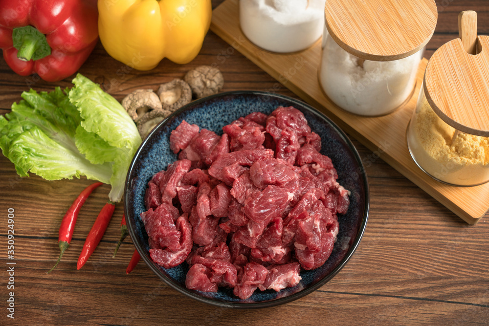Raw beef with wooden table background