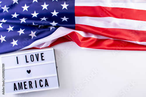 I LOVE AMERICA text in a light box with an American Flag on wthite background. Happy Memorial Day, Independence day, Veterans day. Copy space for advertisers. photo