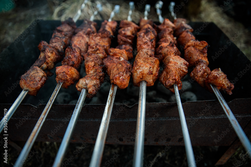 Ready shish kebabs on the grill.Barbecue on the grill. Very juicy fresh. BBQ
Marinated shashlik preparing on a barbecue grill over charcoal. Shashlyk (skewered meat) was originally made of lamb. 