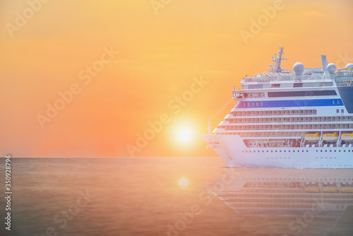 Fototapeta Naklejka Na Ścianę i Meble -  Cruise ship, large luxury white cruise ship liner sailing in the sea with sunset background