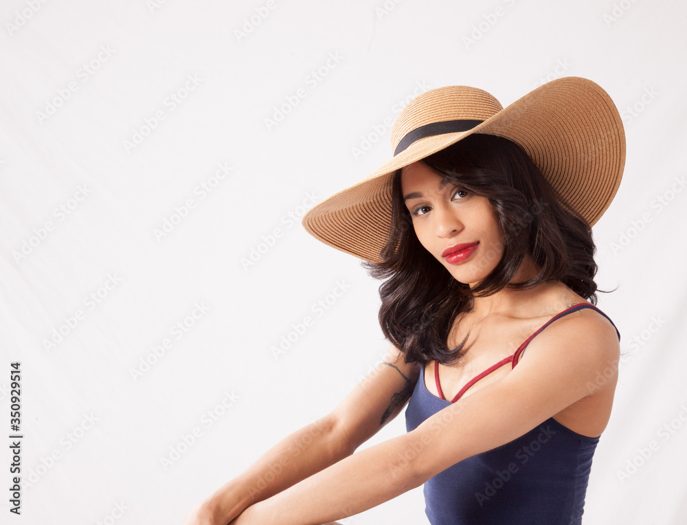 Lovely woman in straw hat sitting thoughtfully Lovely woman in straw hat sitting thoughtfully